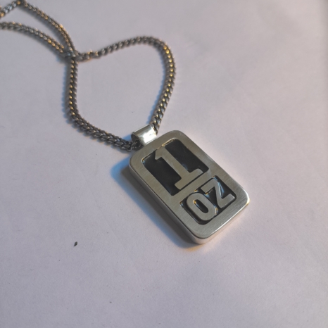 Morrissey “Vauxhall And I” 1 oz sterling silver necklace with black uv enamel, with sterling silver diamond-cut curb chain. pendant size is 28 x 17mm
Also available <a href="https://nickrule.nz/shop/morrissey-vauxhall-necklace-no-chain">without chain</a>.