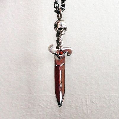 Sterling silver dagger necklace with red garnet and silver chain.