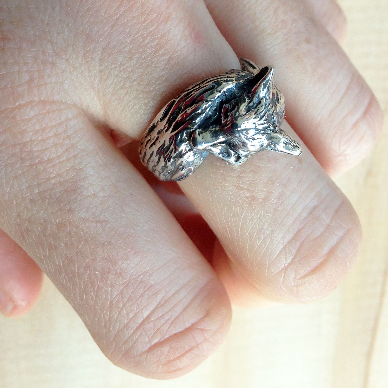 Sterling silver fox ring worn on finger