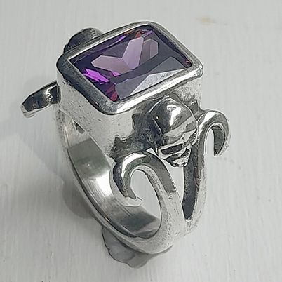 Fine silver skull ring with purple labradorite stone setting.