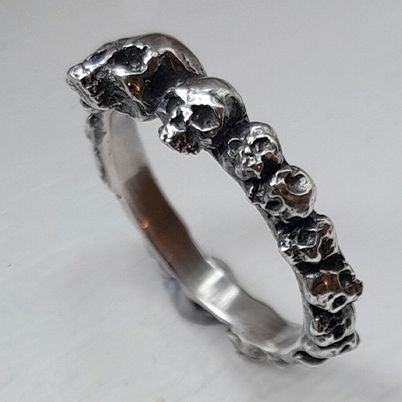 Sterling silver ring of skulls.